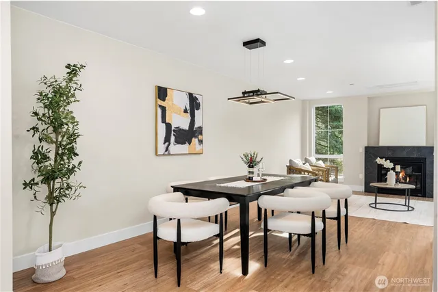 a view of a livingroom and dining room with furniture wooden floor and a potted plant