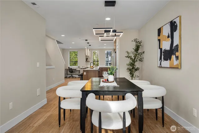 a view of a dining room with furniture and wooden floor