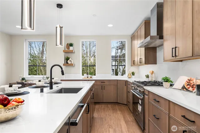 a kitchen with stainless steel appliances granite countertop a sink and a stove