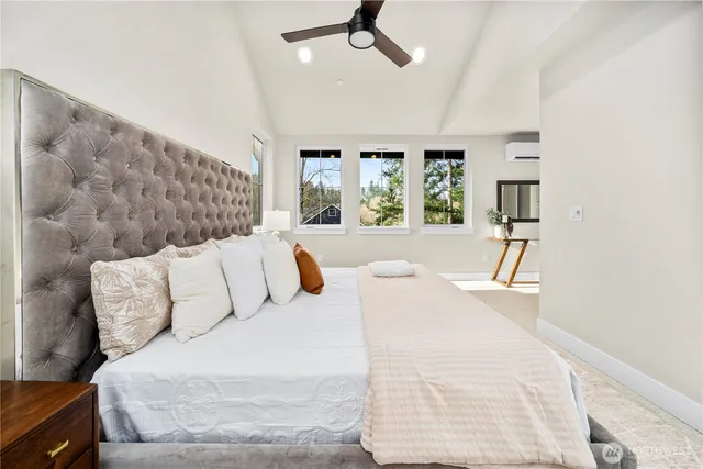 a large white bed in a white room