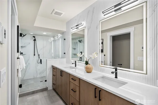 a bathroom with a double vanity sink mirror and double