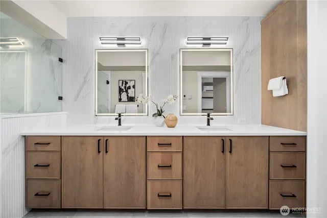 a bathroom with a double vanity sink and mirror