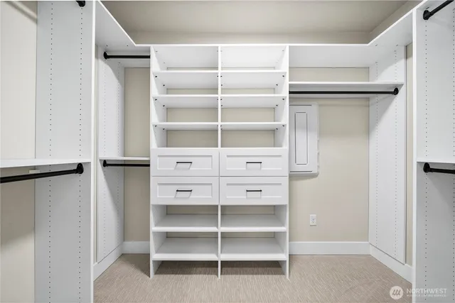 a view of walk in closet with empty racks