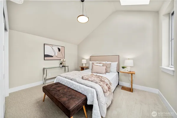 a bedroom with a bed lamp and a window
