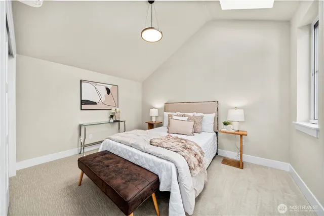 a bedroom with a bed lamp and a window