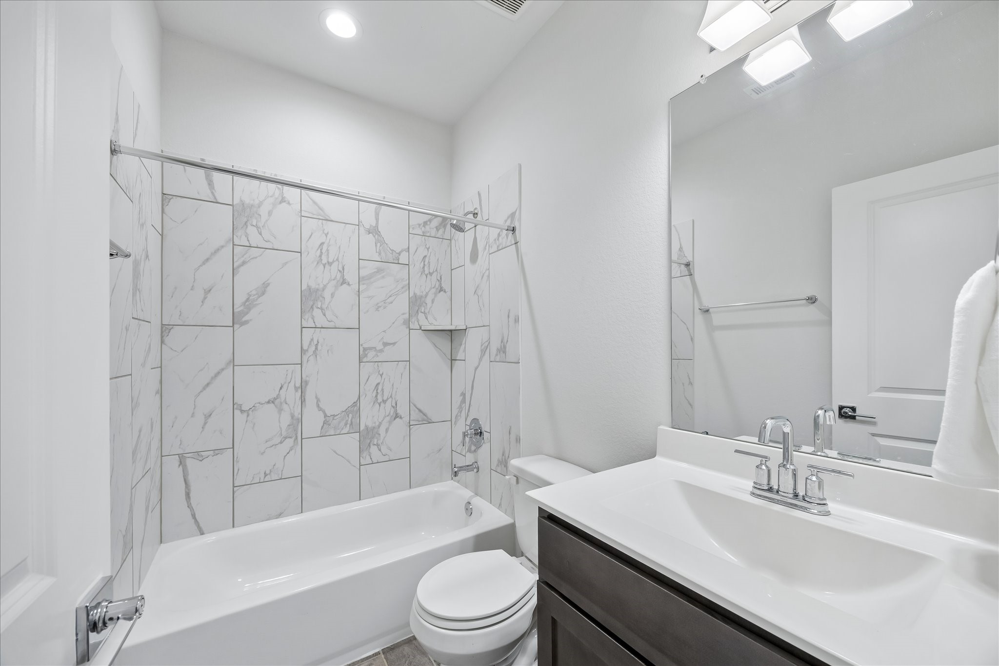 33002 Carolyns Perfection Loop Fulshear, TX 77441 - Photo 24 of 29 a bathroom with a sink a toilet a mirror a bathtub and shower