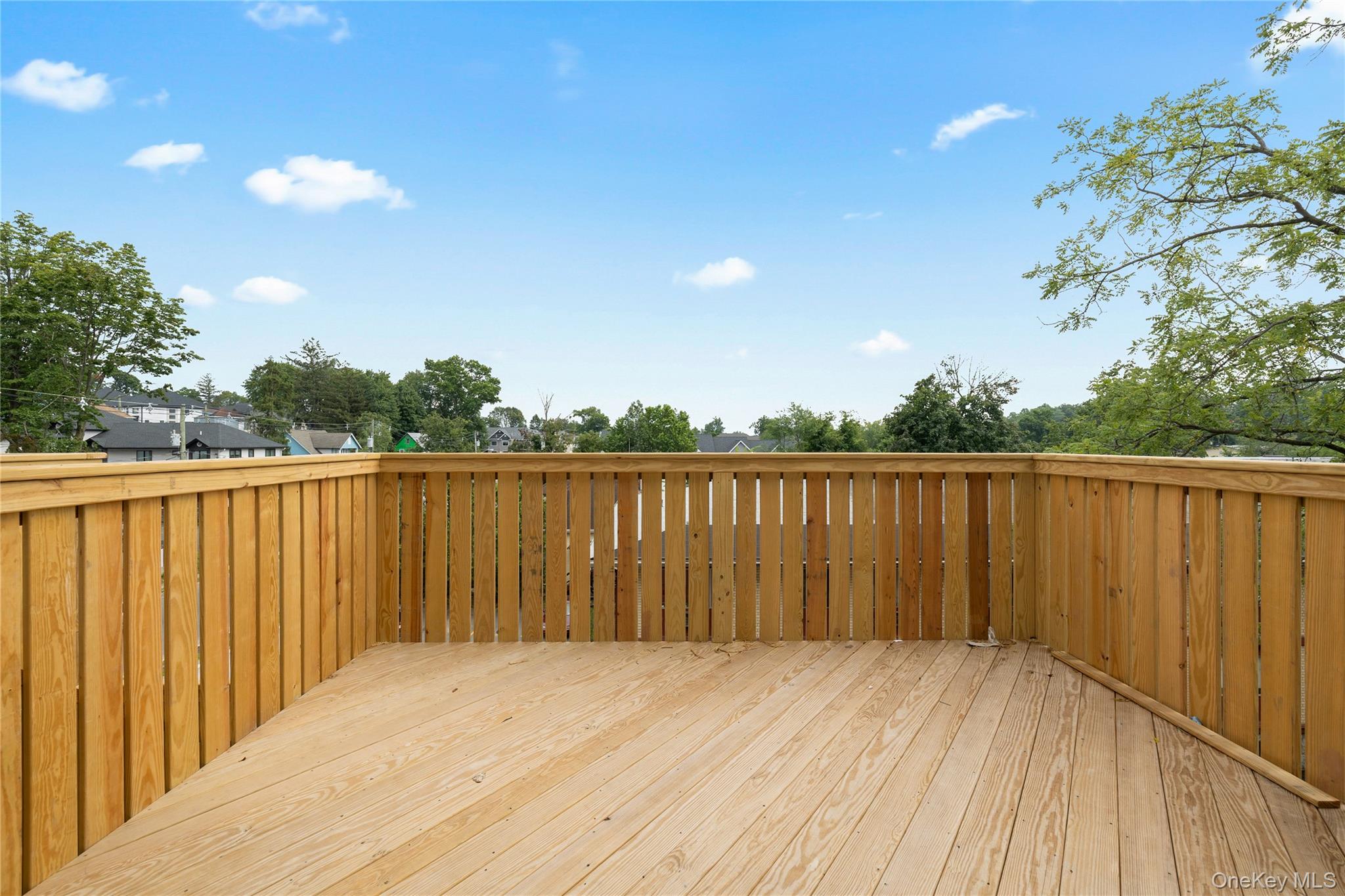 15 Ridge Avenue, Unit 101 Spring Valley, NY 10977 - Photo 16 of 41 a view of deck with wooden floor and fence