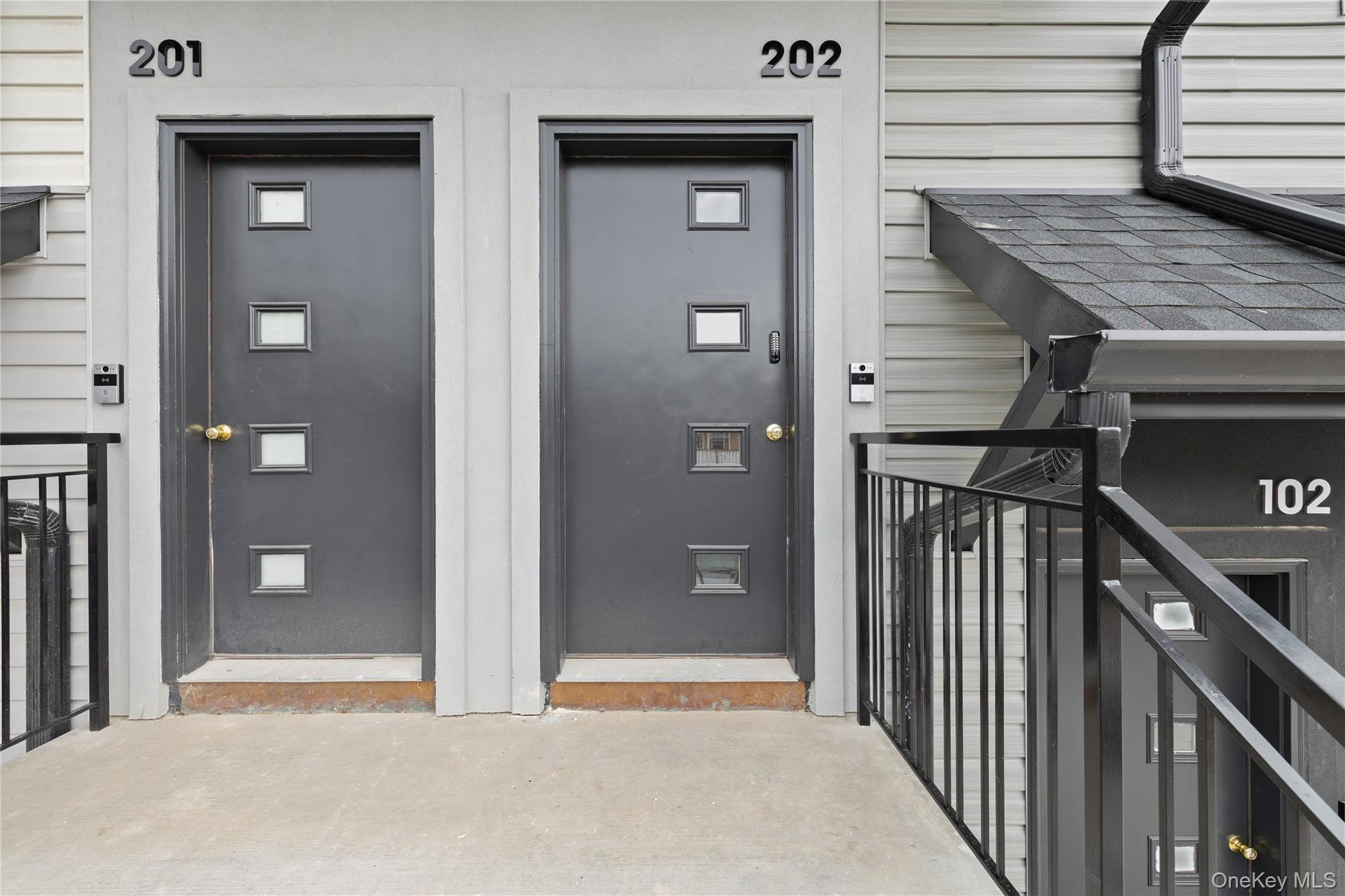 15 Ridge Avenue, Unit 101 Spring Valley, NY 10977 - Photo 2 of 41 a view of a hallway with wooden floor and staircase