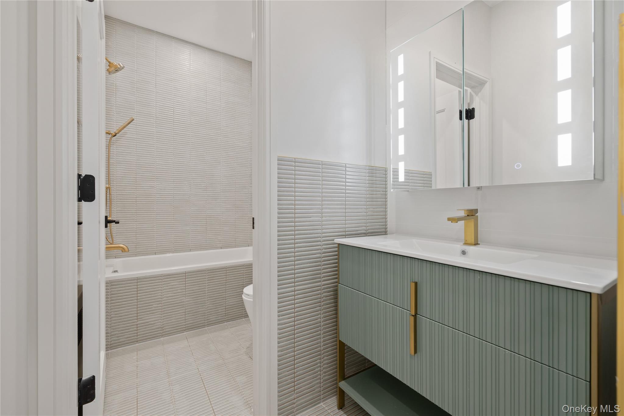 15 Ridge Avenue, Unit 101 Spring Valley, NY 10977 - Photo 37 of 41 a bathroom with a shower sink and mirror