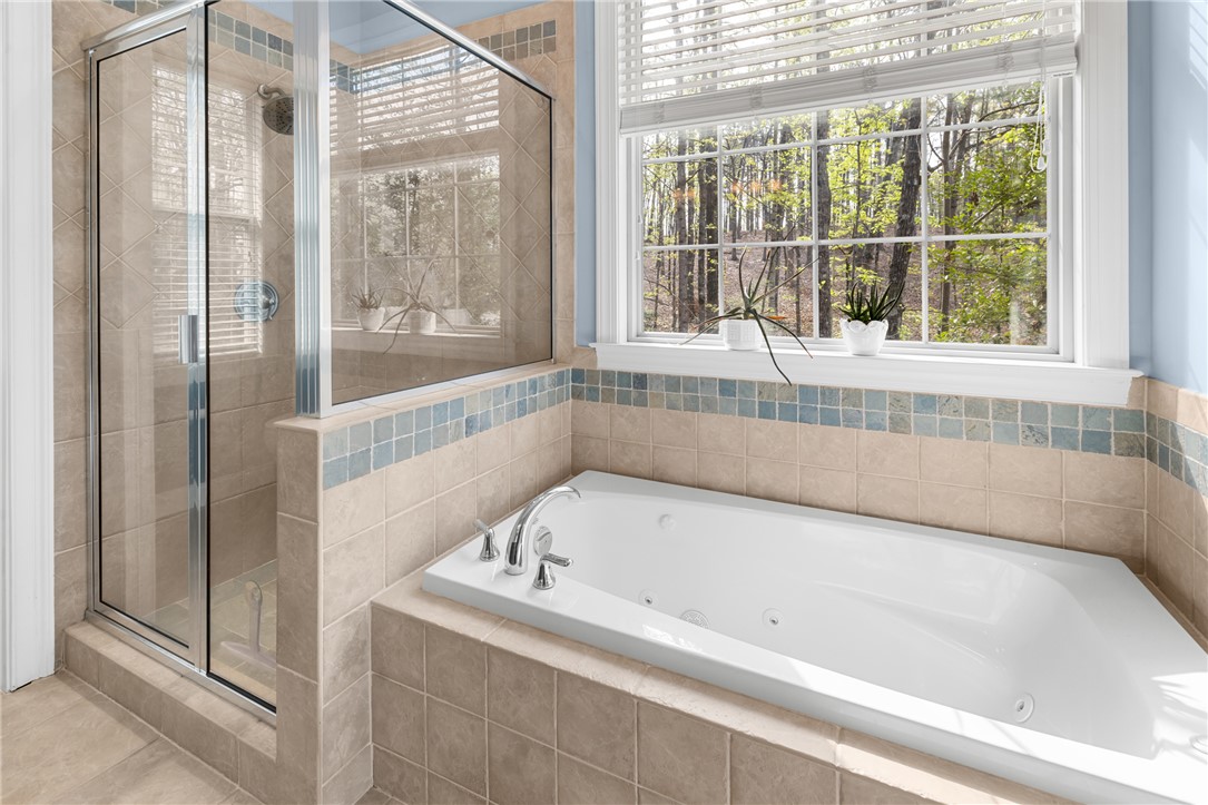 3 Halyard Way Salem, SC 29676 - Photo 18 of 48 This serene bathroom offers a spa-like retreat with a jetted tub and a view of nature.