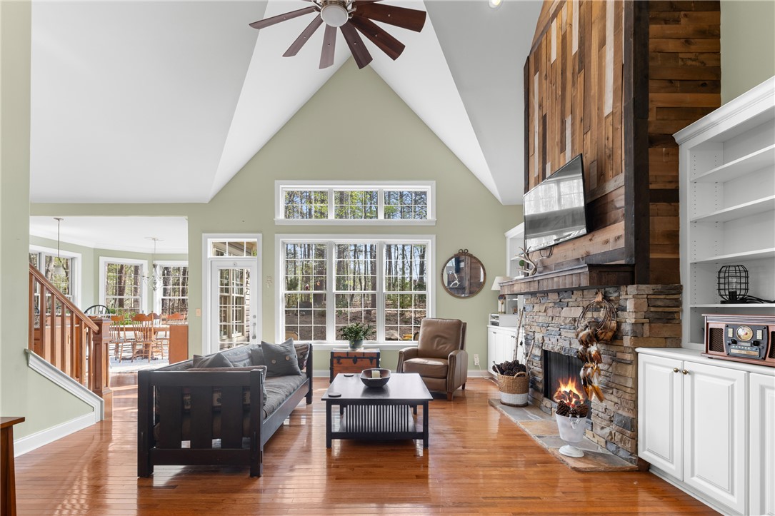 3 Halyard Way Salem, SC 29676 - Photo 4 of 48 Bright and airy living area featuring a stone fireplace and rich hardwood flooring.