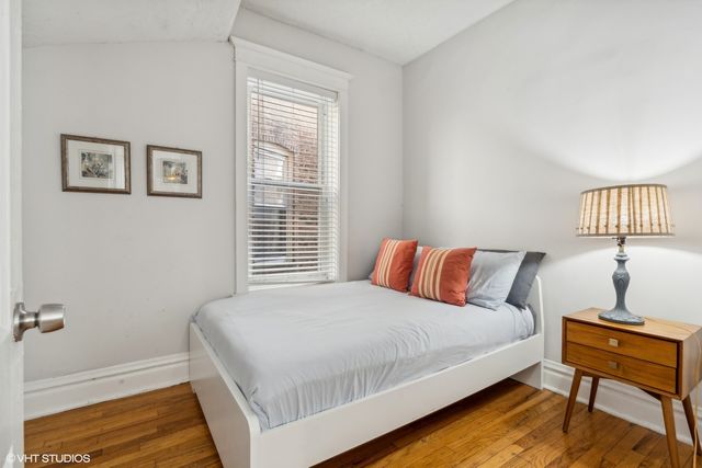 a bedroom with a bed and a desk