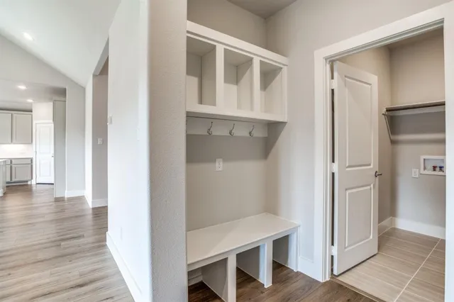 a view of a hallway with wooden floor and entryway