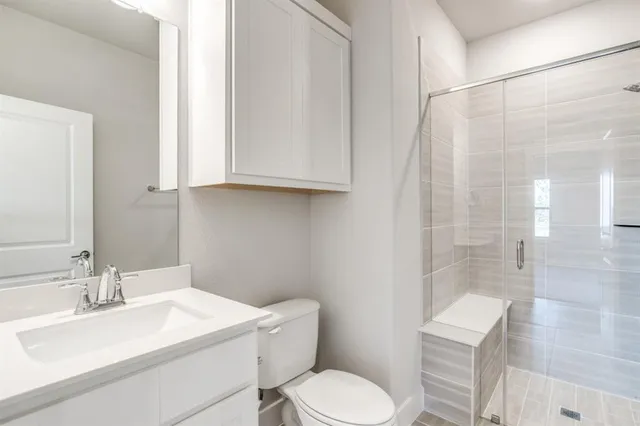 a bathroom with a sink toilet and shower