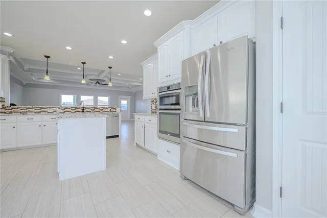 a view of empty room with wooden floor and window