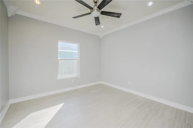 an empty room with a white cabinet and a ceiling fan