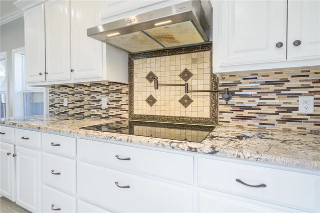 a view of kitchen with a refrigerator cabinets and a window
