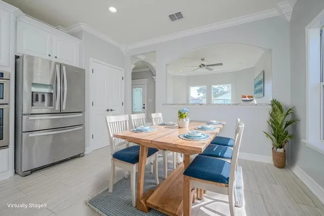 a kitchen with stainless steel appliances kitchen island granite countertop a stove a sink and white cabinets