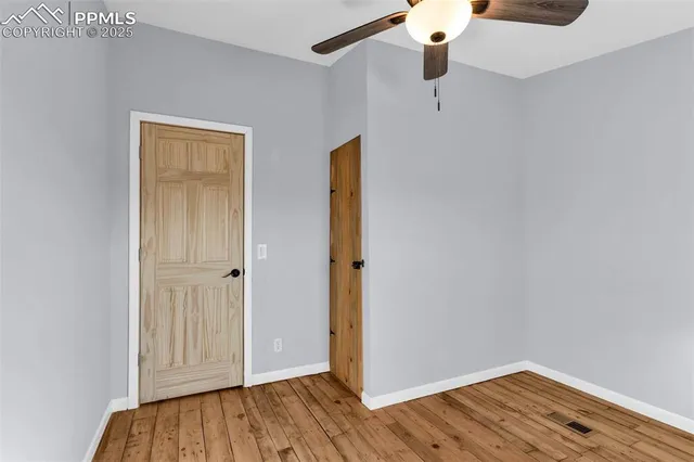 a view of walk in closet with wooden floor