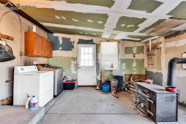 a utility room with cabinets and washer dryer