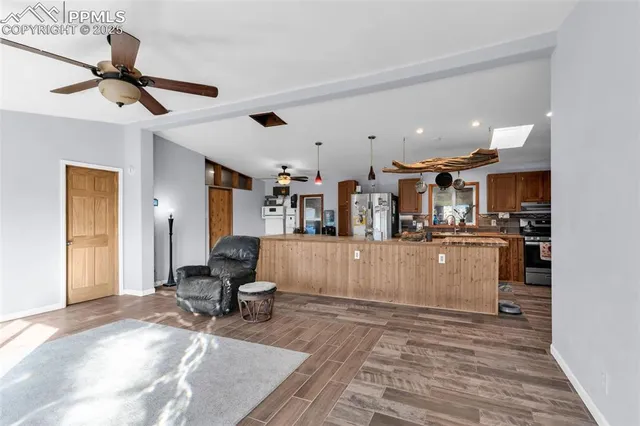 a living room with furniture and kitchen view