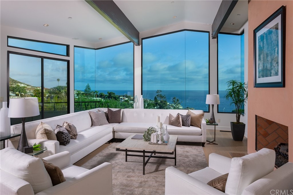 Enter the main level to the living room with white-water ocean and coastal views.