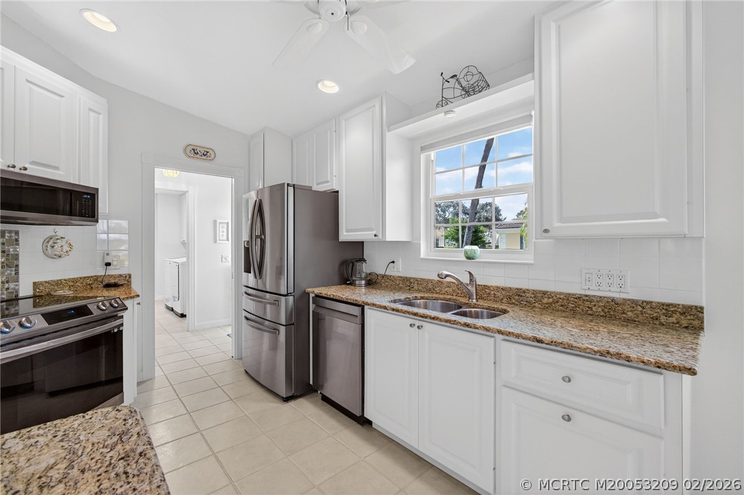 1035 Southwest Tamarrow Place Stuart, FL 34997 - Photo 14 of 46 Crisp, white cabinetry and granite counters