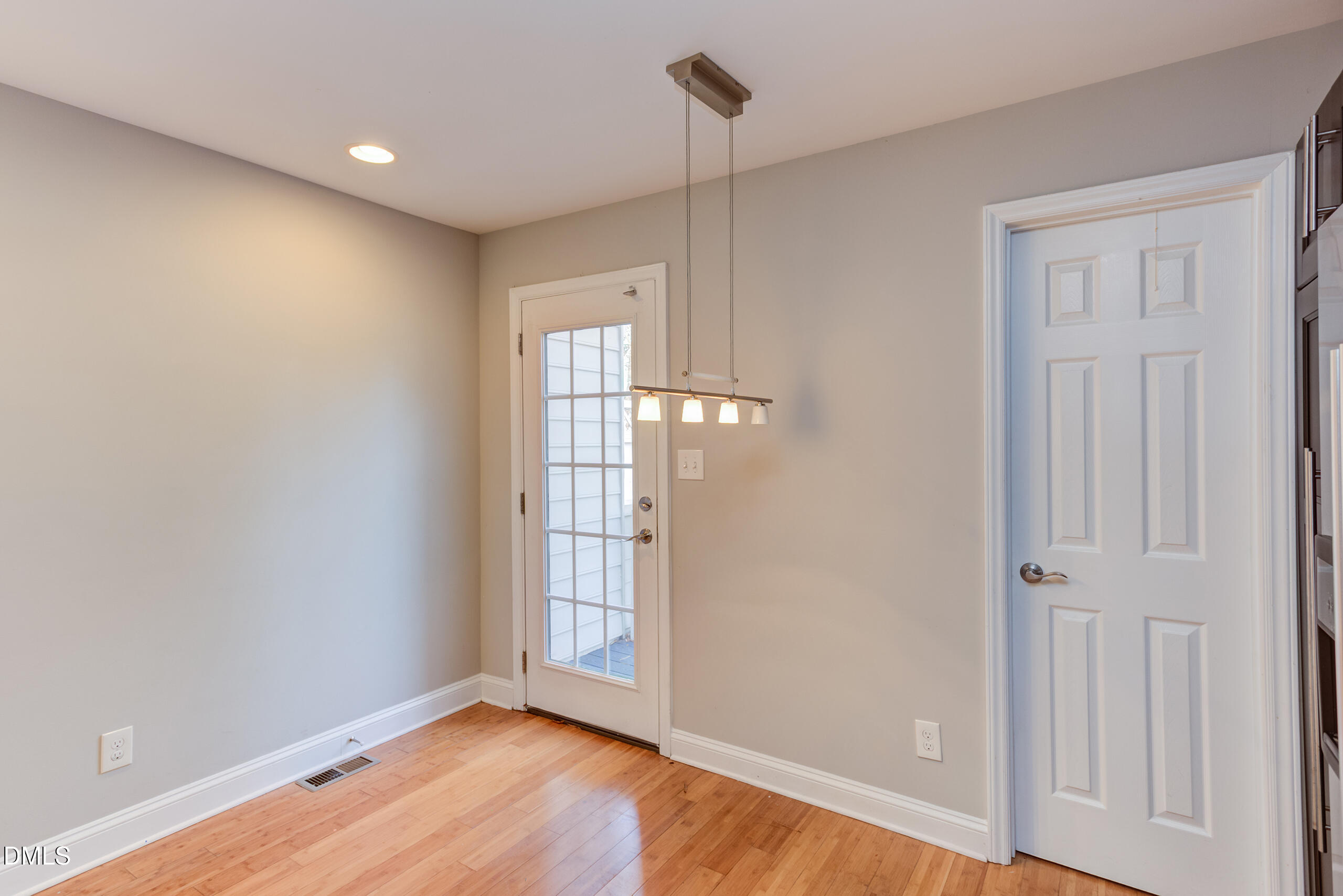 2556 Noble Road Raleigh, NC 27608 - Photo 13 of 29 wooden floor in an empty room with a window