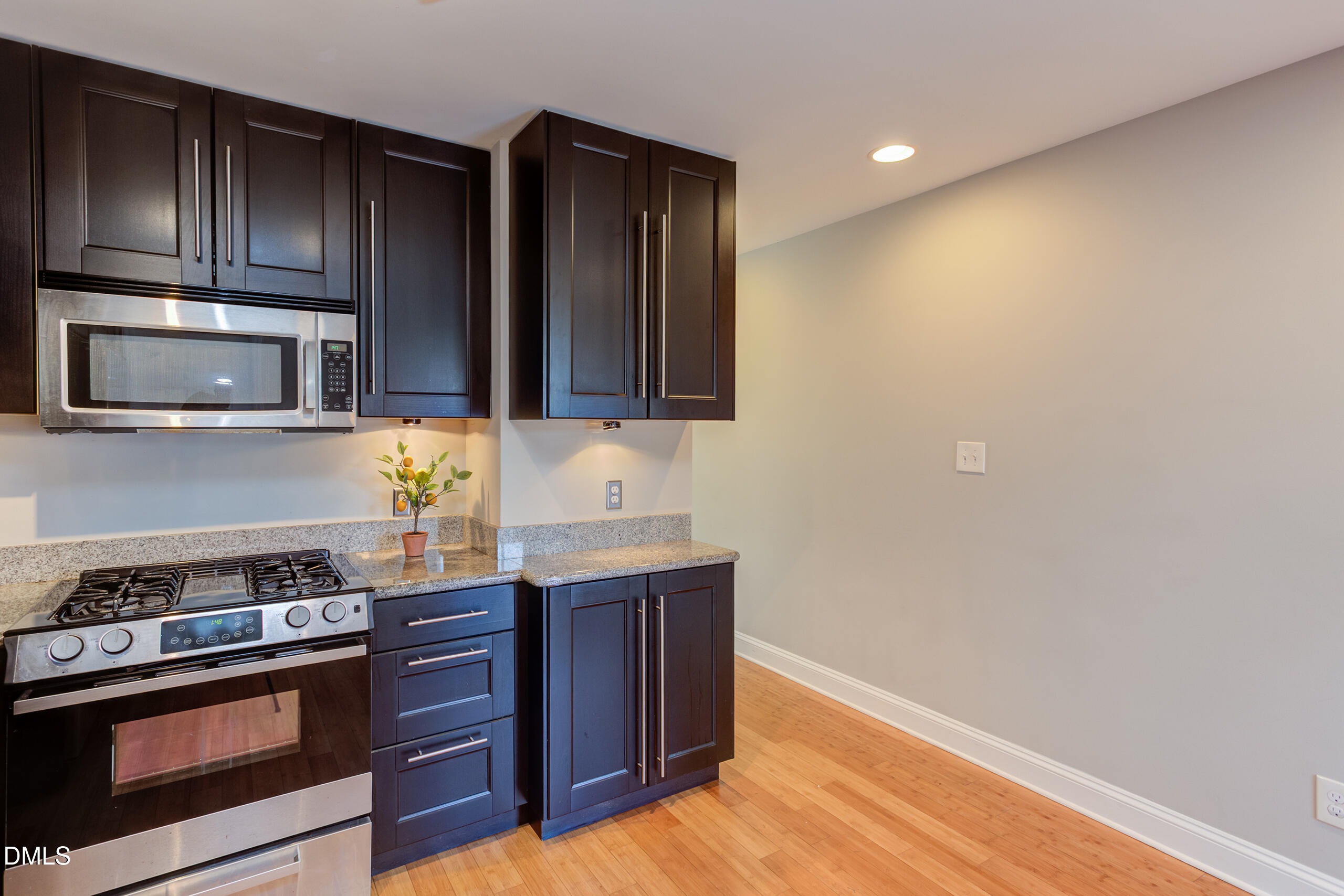 2556 Noble Road Raleigh, NC 27608 - Photo 14 of 29 a kitchen with granite countertop wooden cabinets and stainless steel appliances