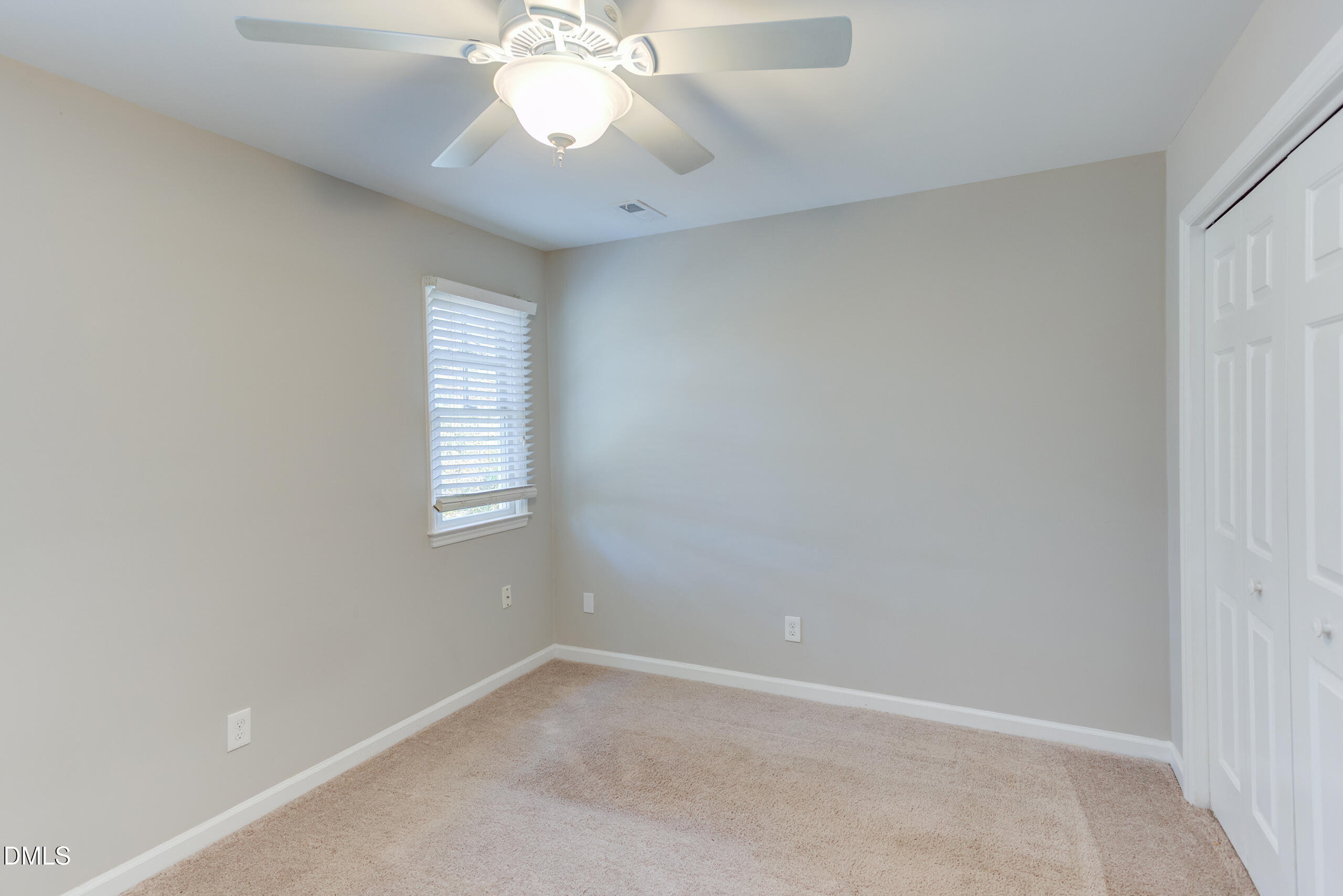 2556 Noble Road Raleigh, NC 27608 - Photo 16 of 29 an empty room with a chandelier fan and windows