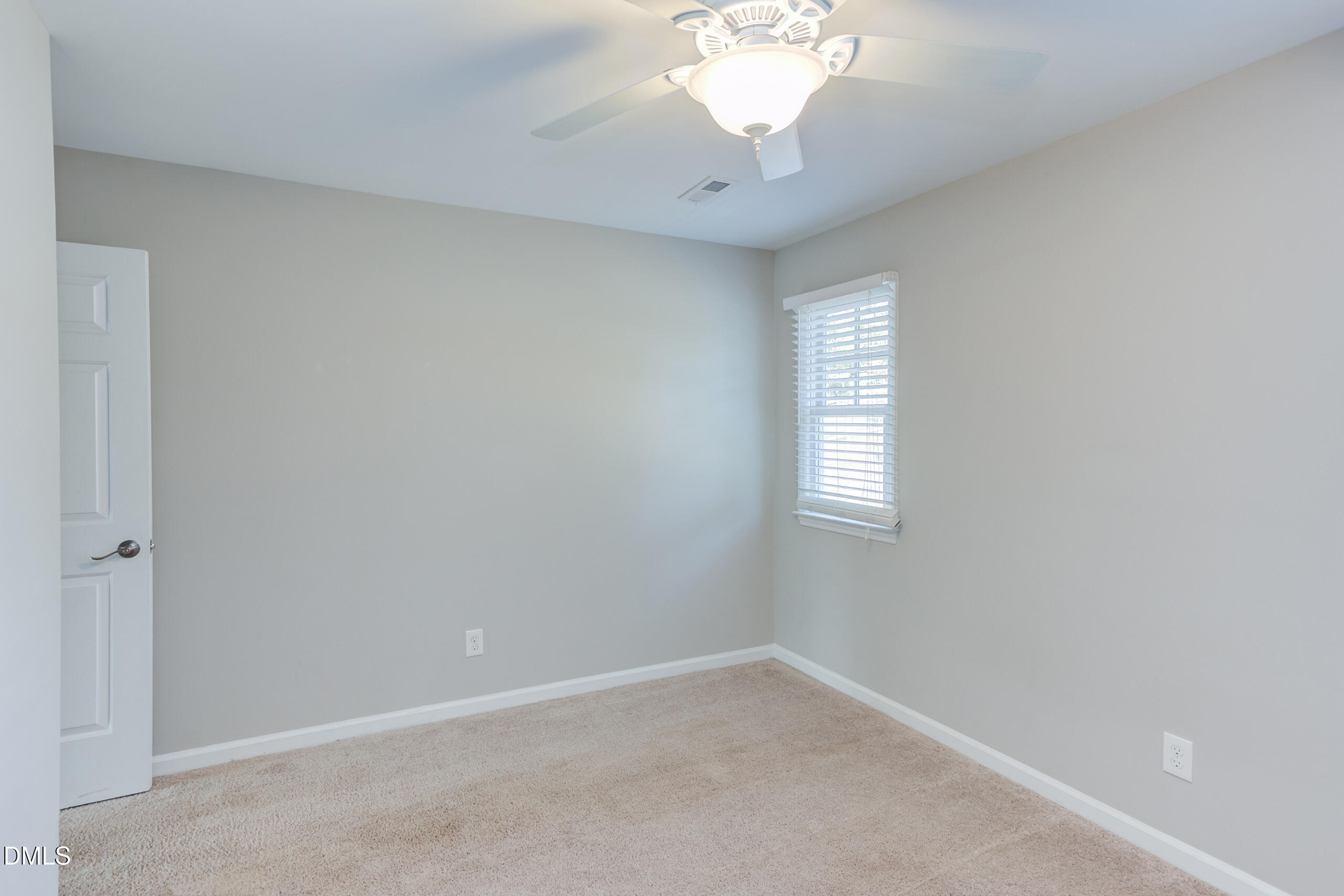 2556 Noble Road Raleigh, NC 27608 - Photo 17 of 29 an empty room with a chandelier fan and windows