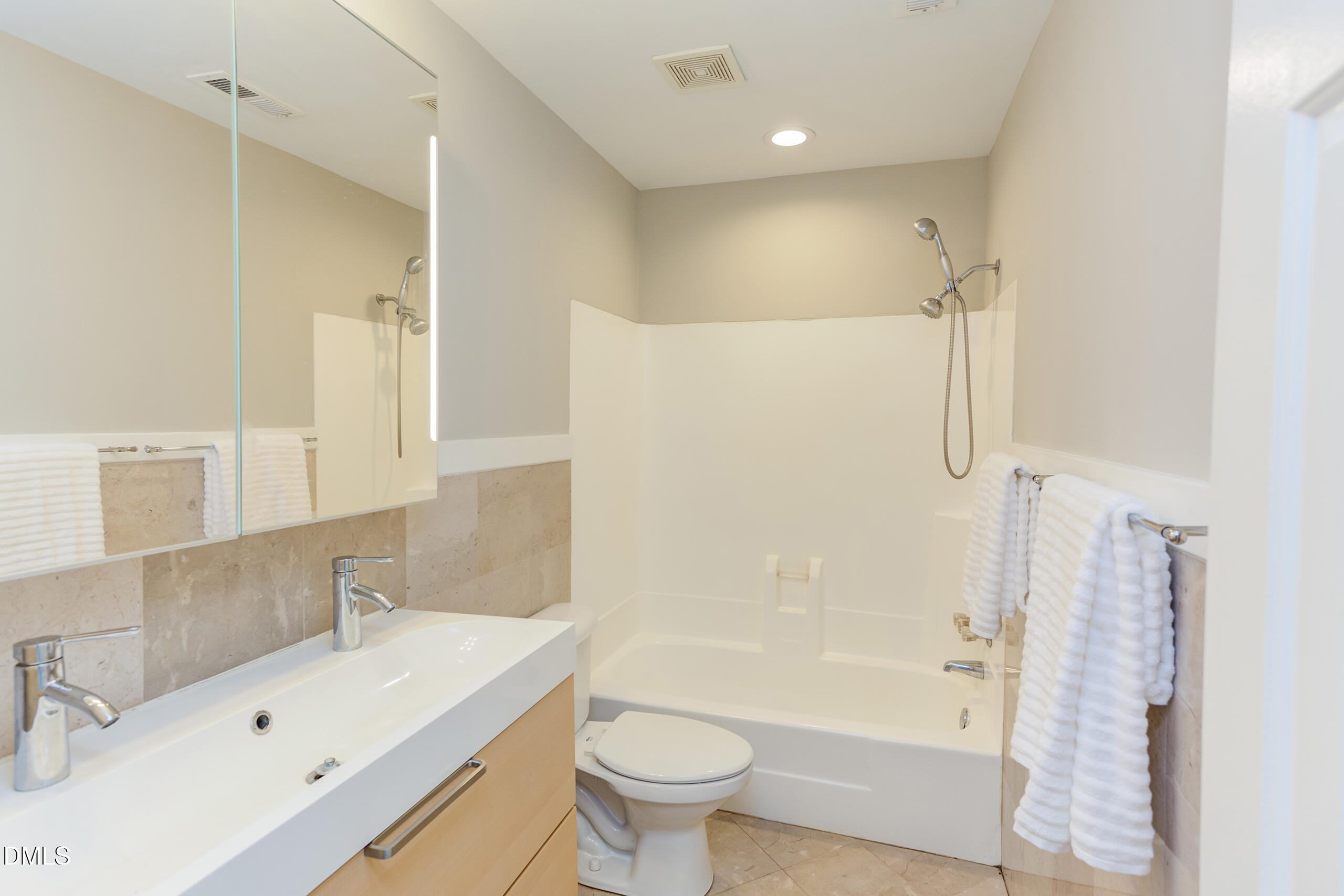 2556 Noble Road Raleigh, NC 27608 - Photo 18 of 29 a bathroom with a sink toilet and shower
