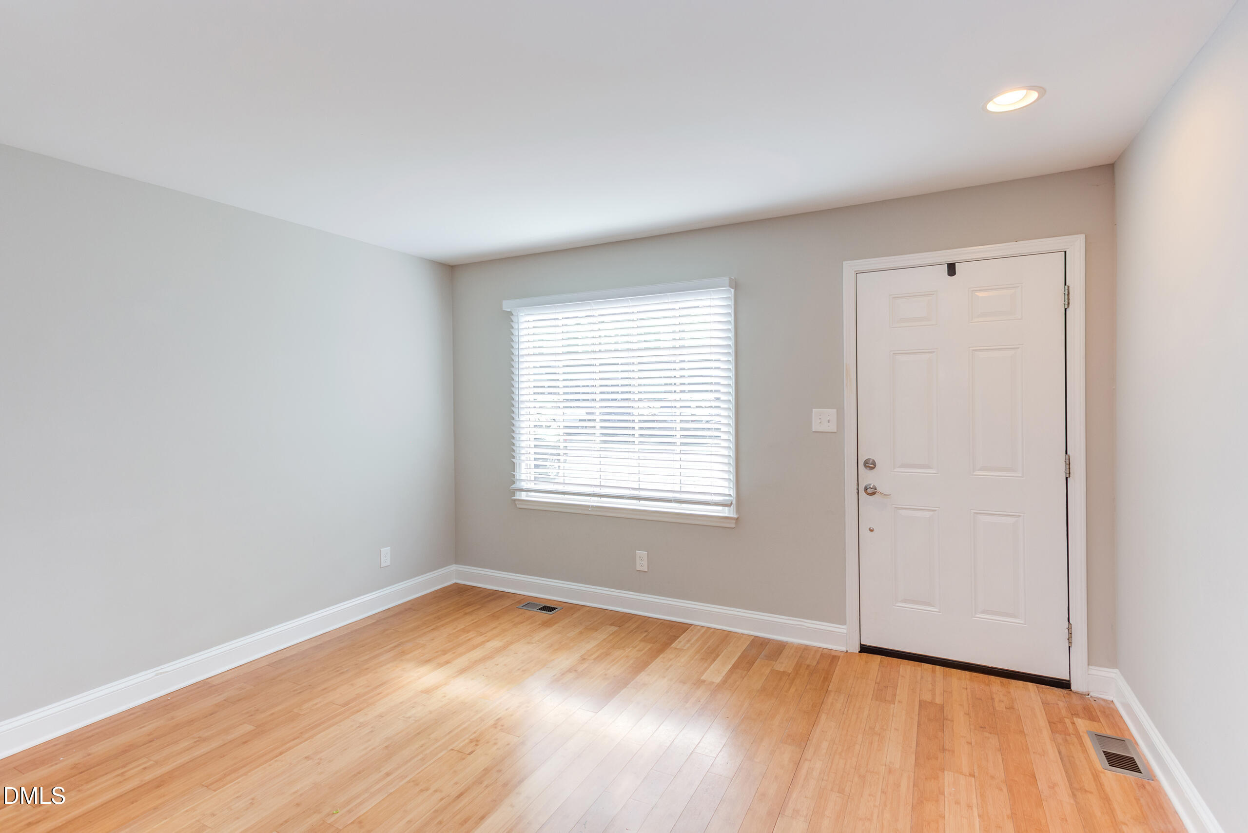 2556 Noble Road Raleigh, NC 27608 - Photo 4 of 29 an empty room with wooden floor and windows