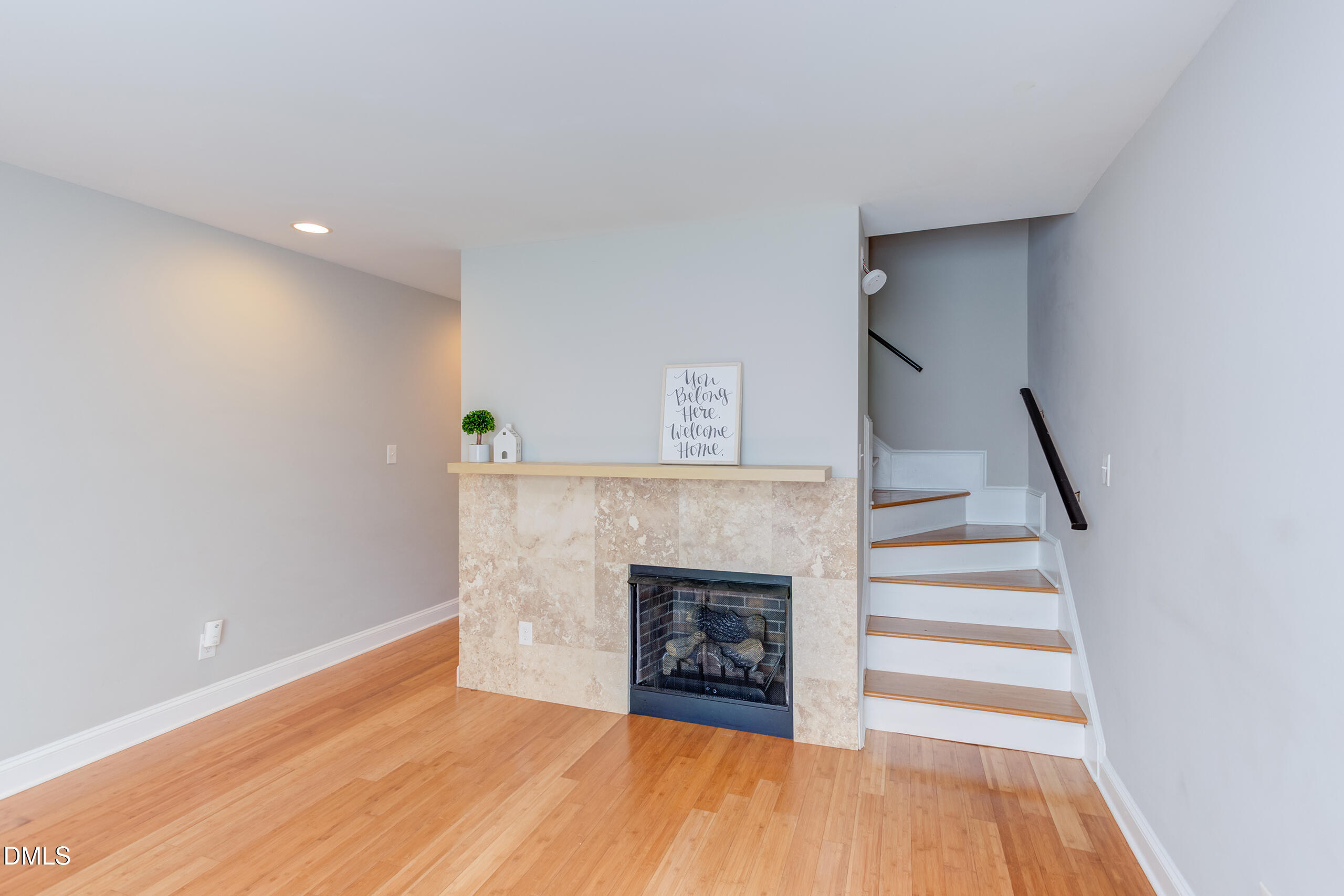 2556 Noble Road Raleigh, NC 27608 - Photo 6 of 29 a view of an empty room with wooden floor fire place