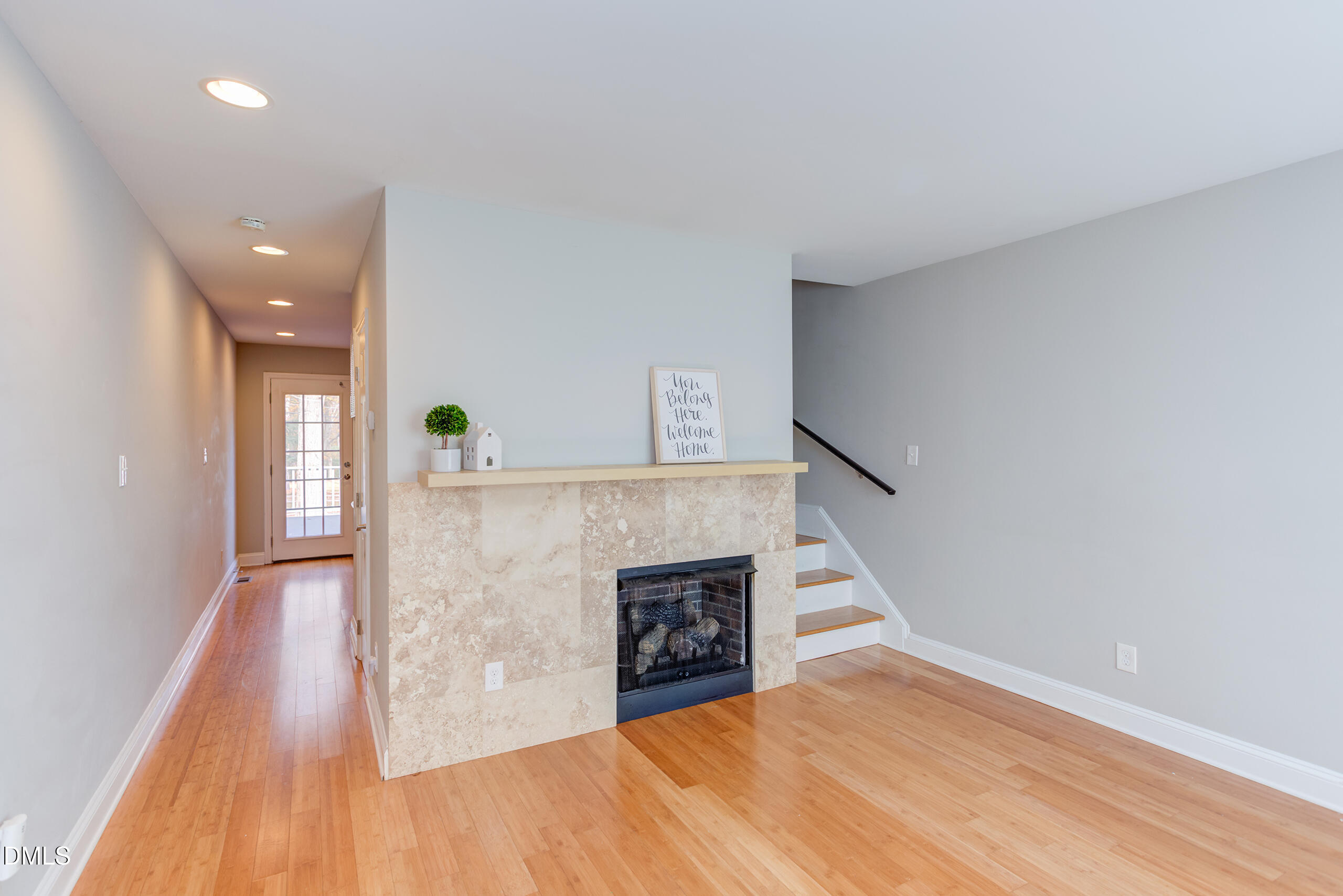 2556 Noble Road Raleigh, NC 27608 - Photo 7 of 29 a view of a livingroom with wooden floor and a fireplace