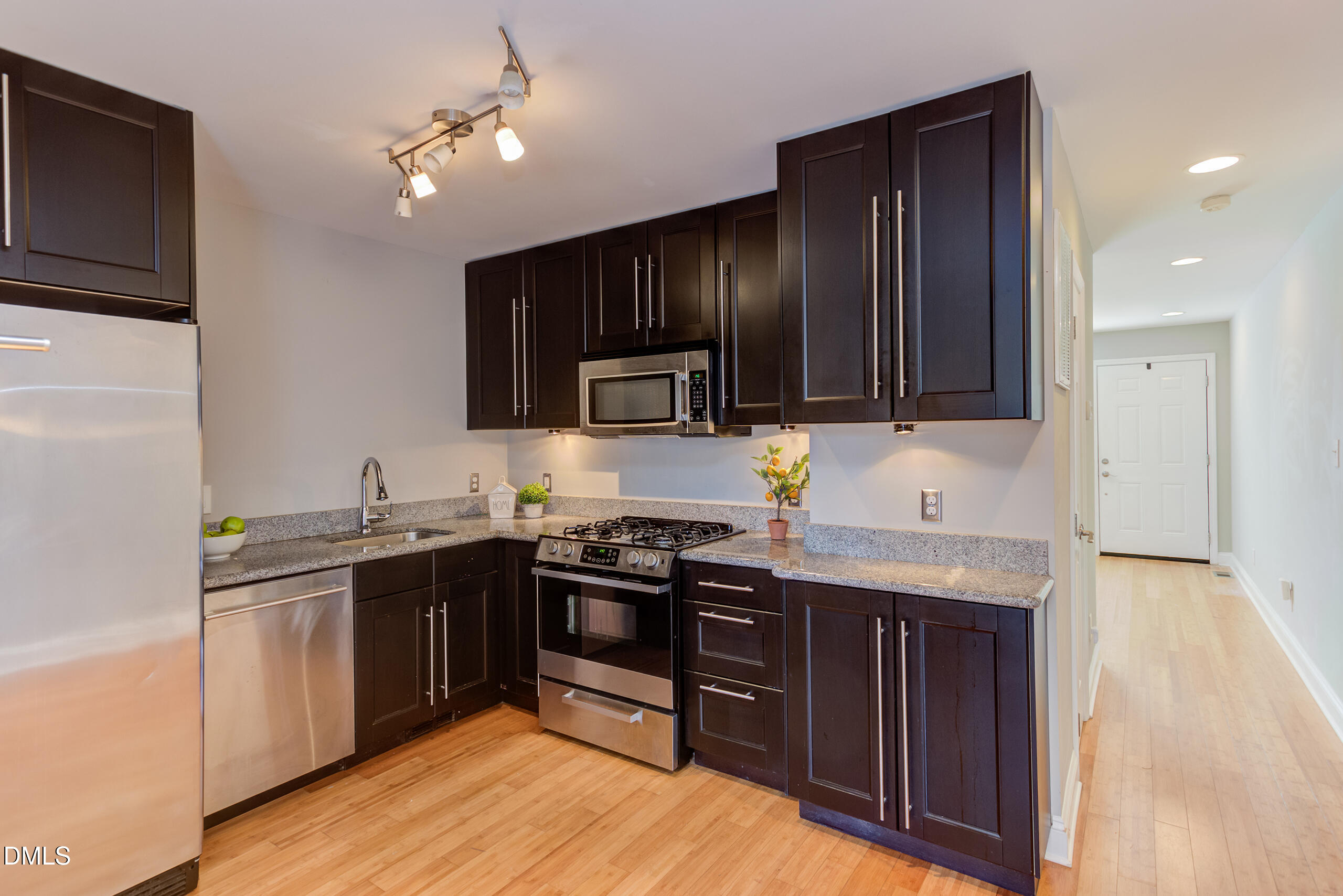 2556 Noble Road Raleigh, NC 27608 - Photo 9 of 29 a kitchen with stainless steel appliances granite countertop wooden cabinets a stove top oven a sink and dishwasher