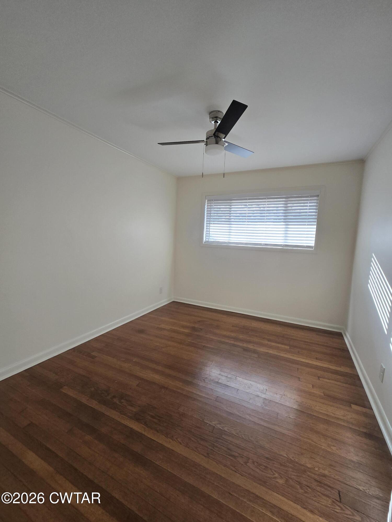 69 Lilac Lane Jackson, TN 38301 - Photo 17 of 23 a view of empty room with wooden floor and fan