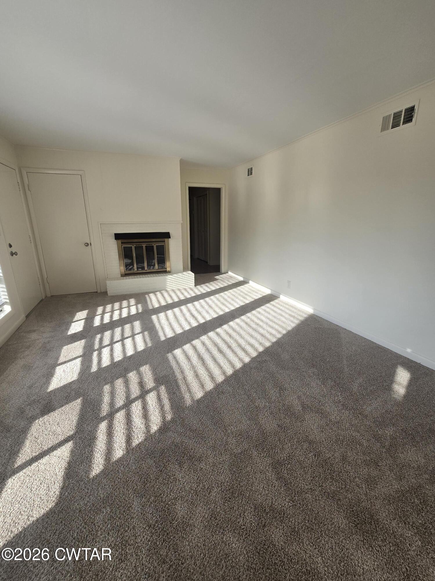 69 Lilac Lane Jackson, TN 38301 - Photo 5 of 23 a view of a bedroom with wooden floor and white walls