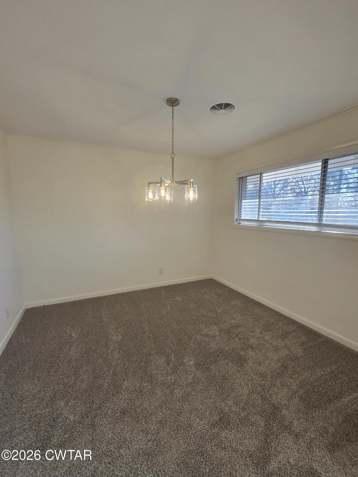 69 Lilac Lane Jackson, TN 38301 - Photo 7 of 23 a view of a room with a chandelier fan