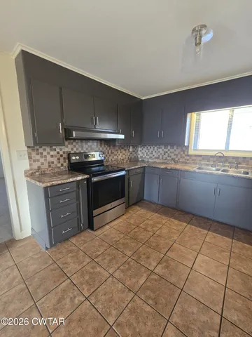 a kitchen with stainless steel appliances granite countertop a sink and cabinets