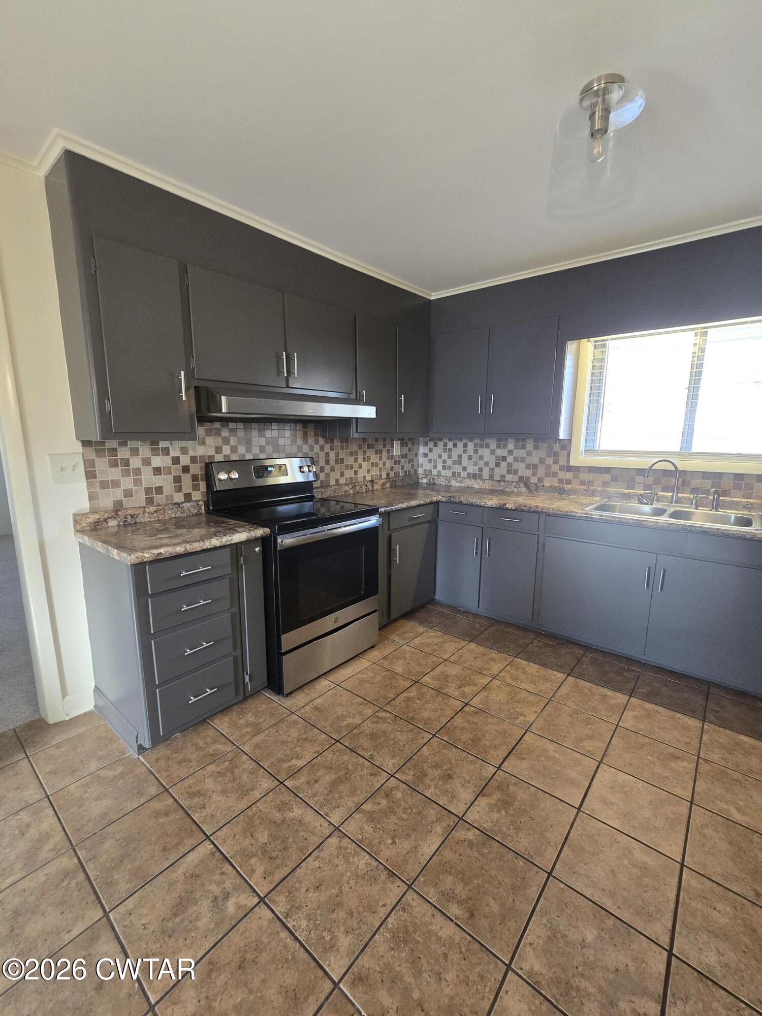69 Lilac Lane Jackson, TN 38301 - Photo 10 of 23 a kitchen with stainless steel appliances granite countertop a sink and cabinets