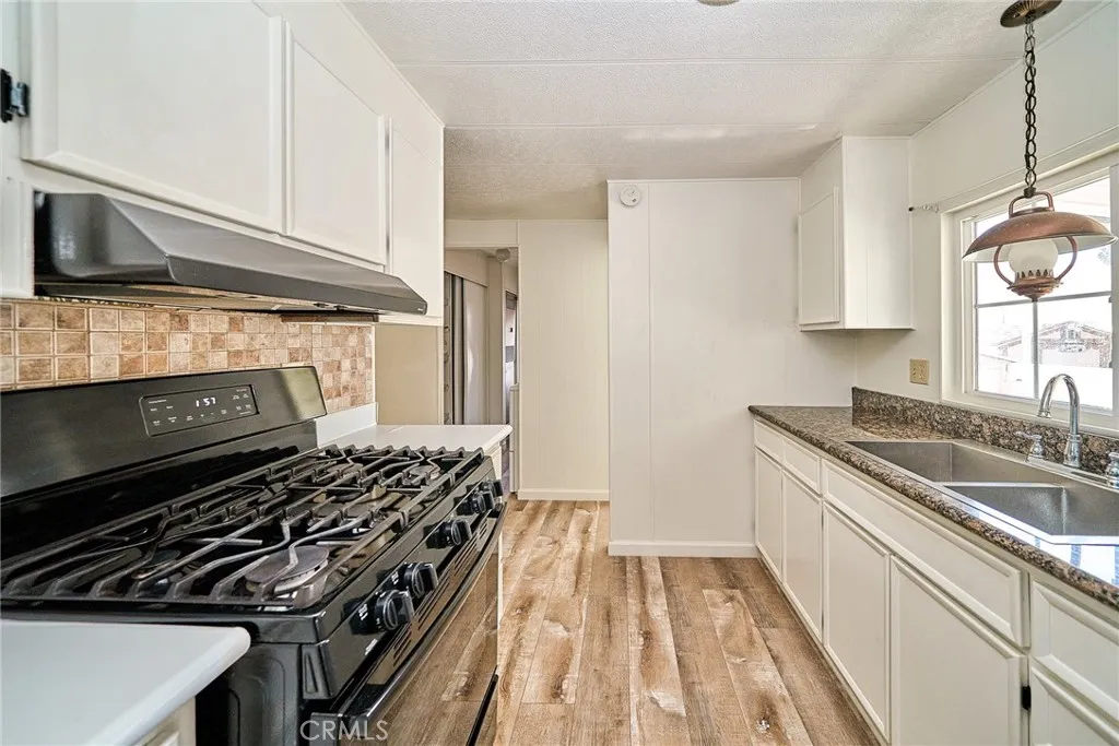4000 Pierce Street, Unit 168 Riverside, CA 92505 - Photo 9 of 34 a kitchen with a stove and a sink