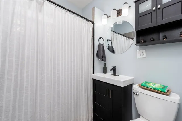 a bathroom with a sink a toilet and a mirror