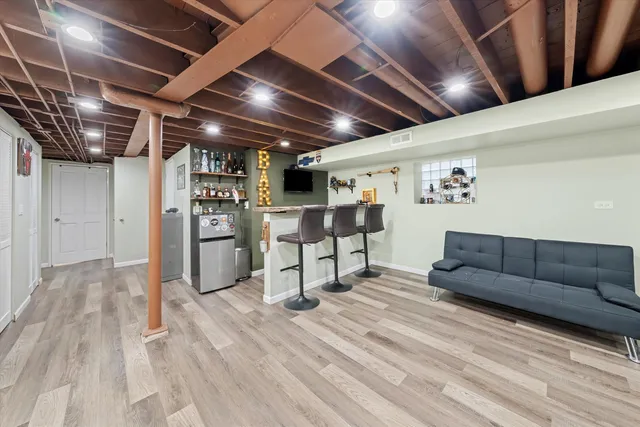 a living room with furniture and a ceiling fan