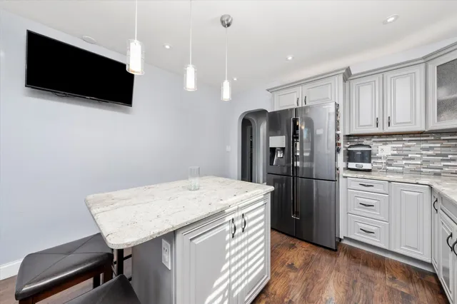 a kitchen with a appliances a refrigerator and microwave