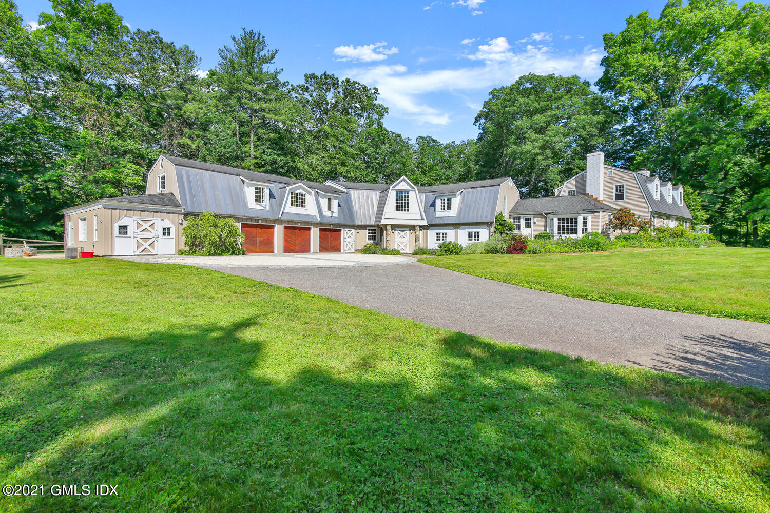 a front view of a house with a yard and trees