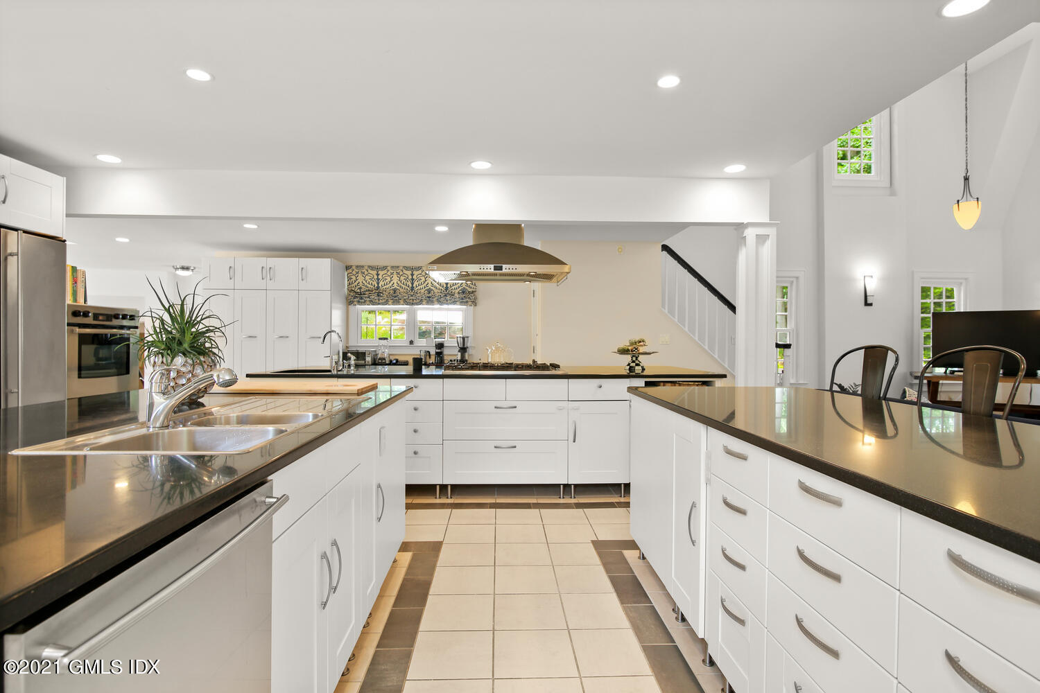 61 River Road Weston, CT 06883 - Photo 13 of 35 a large white kitchen with a sink and dishwasher