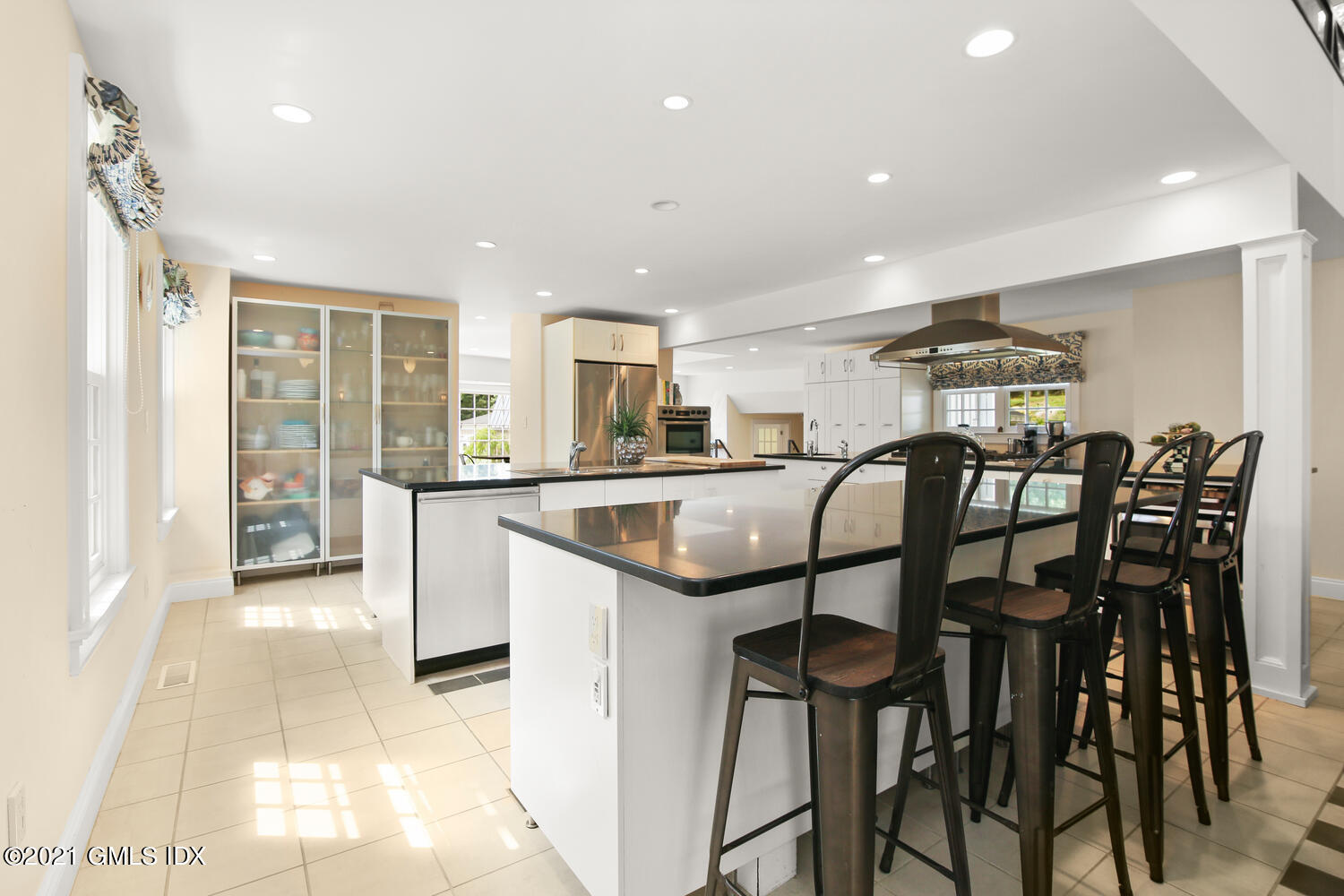 61 River Road Weston, CT 06883 - Photo 14 of 35 a kitchen with granite countertop sink table and chairs