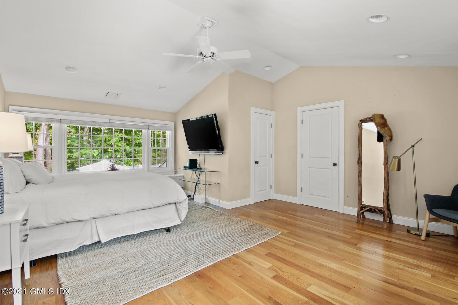 61 River Road Weston, CT 06883 - Photo 19 of 35 a bedroom with a bed window and a flat screen tv
