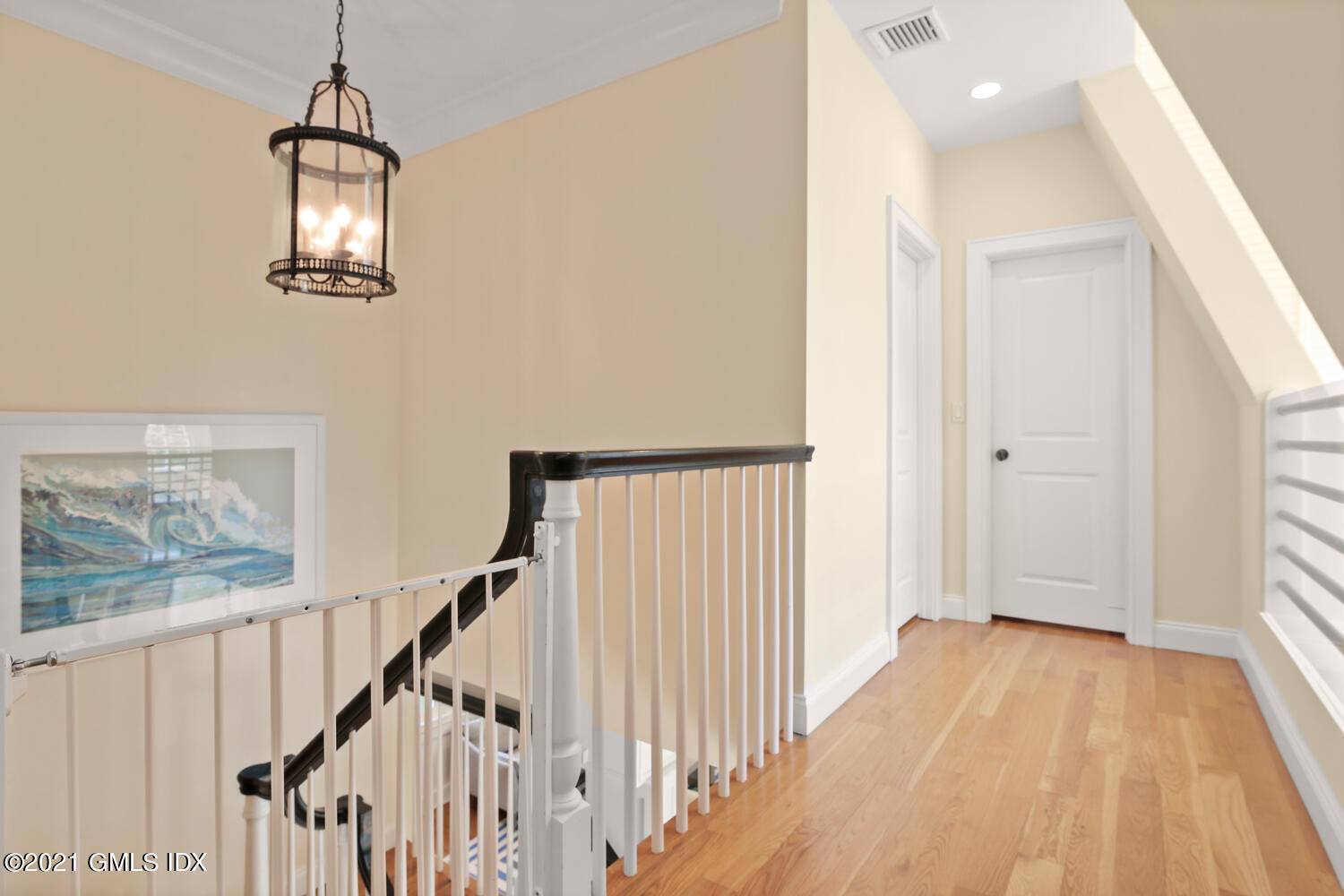 61 River Road Weston, CT 06883 - Photo 22 of 35 a view of a hallway with wooden floor and stairs